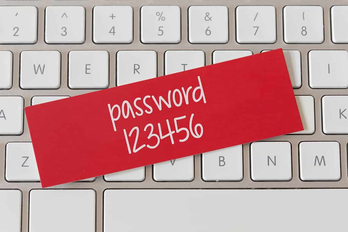 Password strength - password 123456 with white keyboard on background
